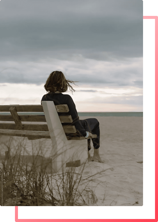 A woman on a bench enjoying a sense of inner-peace and self-love for the first time since conquering her anxiety.