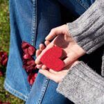 Hands holding a felt heart to denote compassion, forgiveness and patience for the sake of our own self-love and inner-peace.